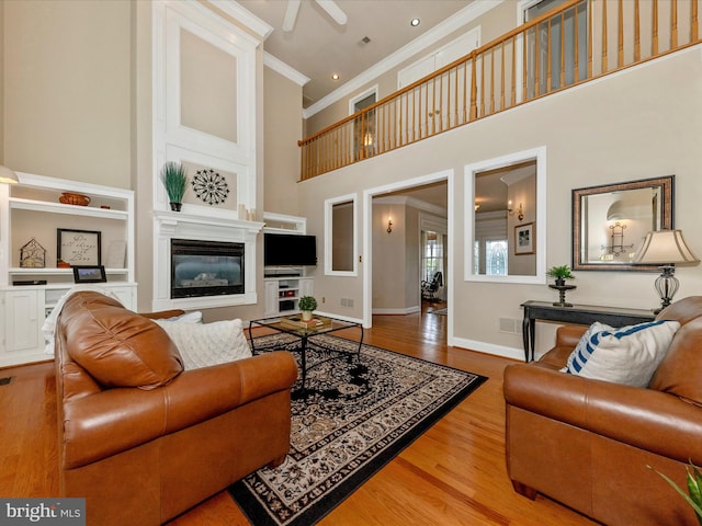 16013 Pheasant Ridge Ct, Woodbine, MD 21797 - living area featuring crown molding, a towering ceiling, wood finished floors, baseboards, and a ceiling fan