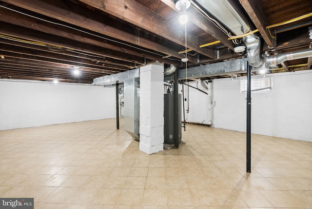 unfinished basement featuring gas water heater