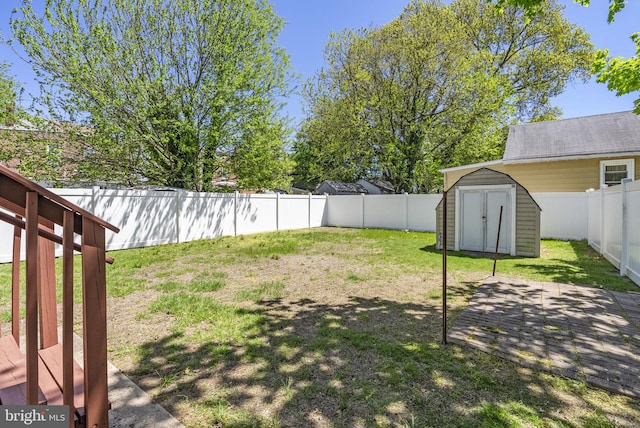view of yard featuring a shed, an outbuilding, and a patio area