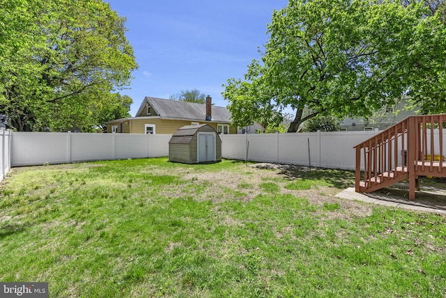 view of yard featuring a storage shed, an outdoor structure, and a deck