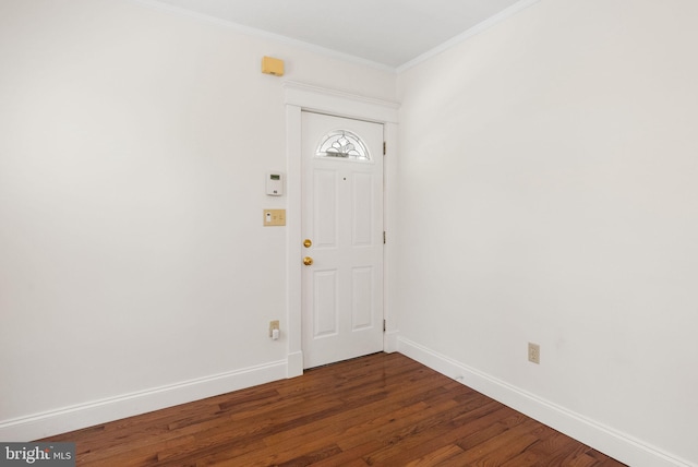 foyer featuring dark wood finished floors, baseboards, and crown molding