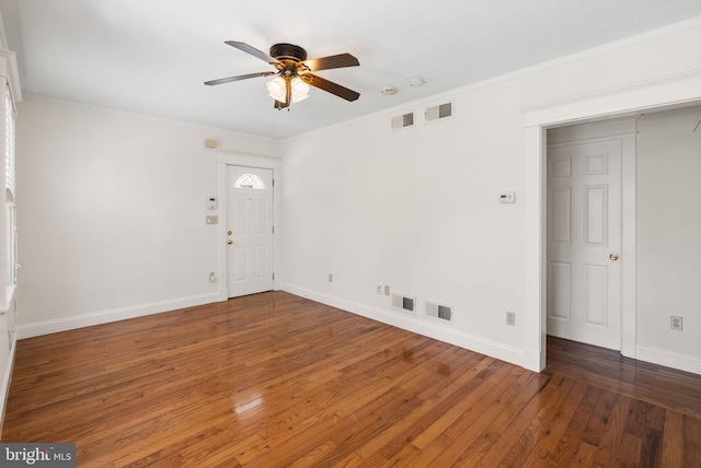 spare room featuring a ceiling fan, hardwood / wood-style flooring, baseboards, ornamental molding, and a smoke detector