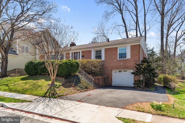 ranch-style home with brick siding, driveway, a garage, and a chimney