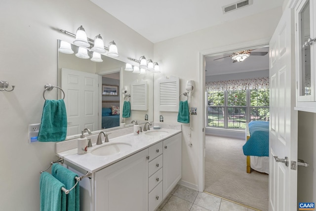 full bathroom featuring ensuite bathroom, double vanity, tile patterned floors, and baseboards