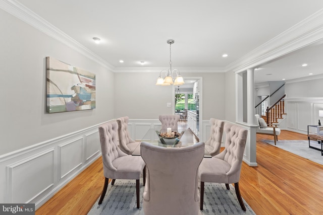 13429 Locksley Ln, Silver Spring, MD 20904 - dining space featuring light wood-style floors, a decorative wall, stairway, ornamental molding, and wainscoting