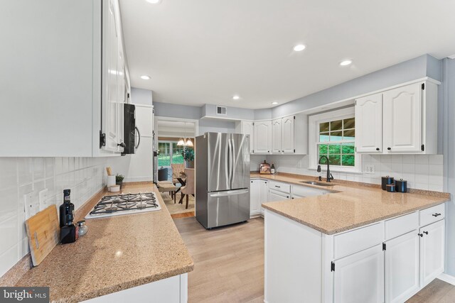 13429 Locksley Ln, Silver Spring, MD 20904 - kitchen featuring stainless steel appliances, a sink, a peninsula, healthy amount of natural light, and recessed lighting