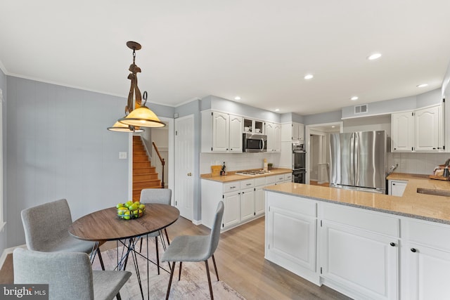 13429 Locksley Ln, Silver Spring, MD 20904 - kitchen with stainless steel appliances, a sink, decorative backsplash, a peninsula, and ornamental molding