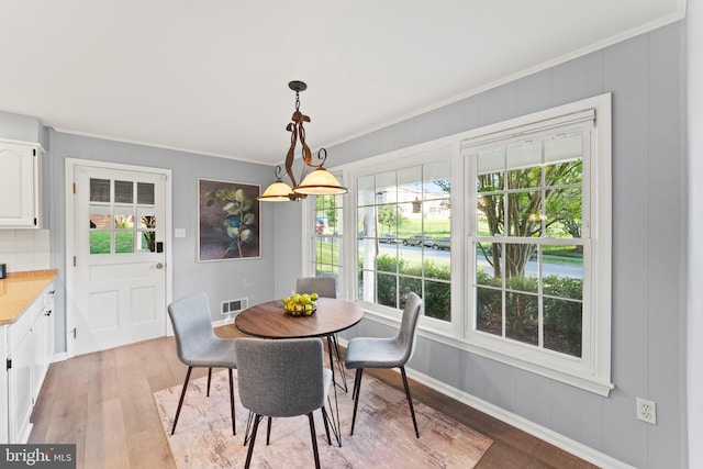 13429 Locksley Ln, Silver Spring, MD 20904 - dining room with light wood-style flooring, ornamental molding, and baseboards