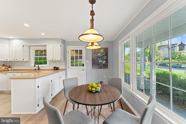 13429 Locksley Ln, Silver Spring, MD 20904 - dining room with crown molding, light wood finished floors, and baseboards