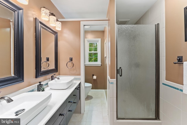 13429 Locksley Ln, Silver Spring, MD 20904 - bathroom featuring a stall shower, toilet, double vanity, and tile patterned flooring