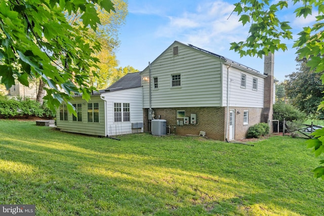 13429 Locksley Ln, Silver Spring, MD 20904 - rear view of house with central AC, a lawn, and brick siding
