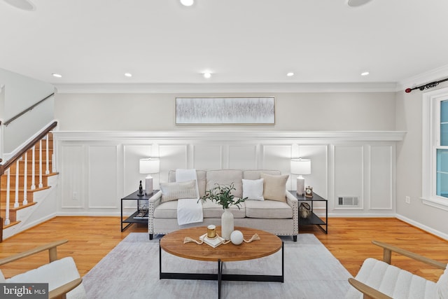 13429 Locksley Ln, Silver Spring, MD 20904 - living area featuring a decorative wall, ornamental molding, stairs, light wood-style floors, and a wainscoted wall