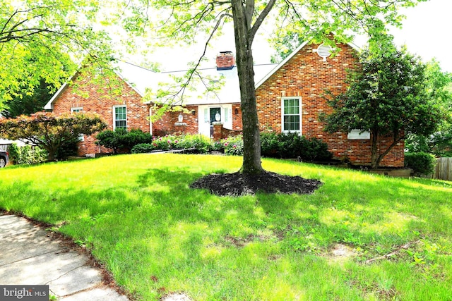 2616 Osage St, Hyattsville, MD 20783 - view of front of home with a chimney, brick siding, and a front yard