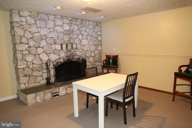 2616 Osage St, Hyattsville, MD 20783 - dining room featuring a textured ceiling, carpet flooring, a fireplace, and baseboards