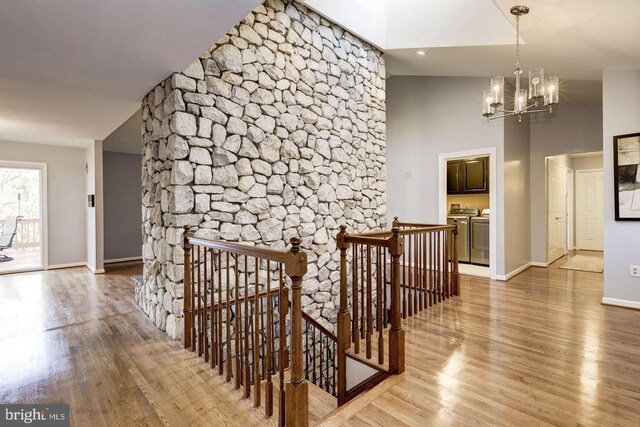 2616 Osage St, Hyattsville, MD 20783 - corridor featuring an upstairs landing, light wood-style flooring, a chandelier, washing machine and dryer, and baseboards