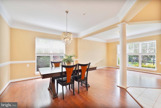 7419 Near Thicket Way, Laurel, MD 20707 - dining space with ornate columns, wood finished floors, baseboards, ornamental molding, and a chandelier