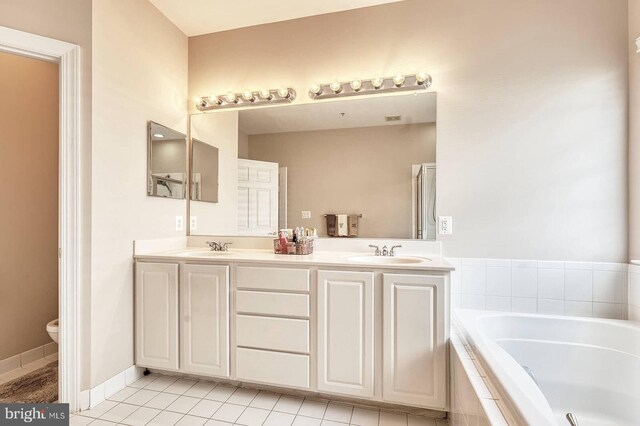 7419 Near Thicket Way, Laurel, MD 20707 - full bath with a garden tub, toilet, double vanity, tile patterned flooring, and a shower with shower door