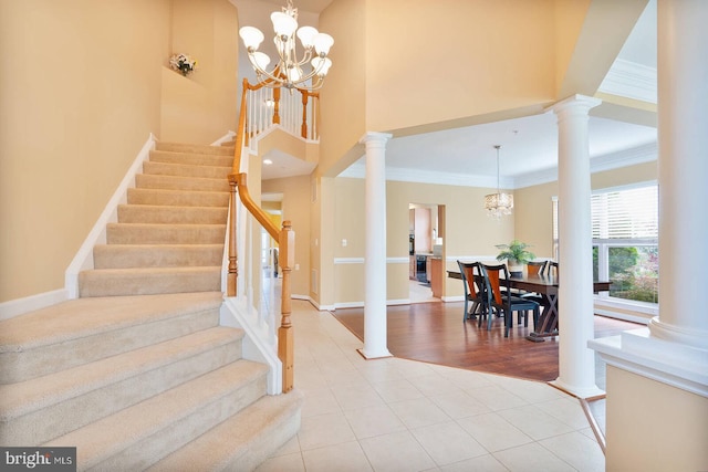 7419 Near Thicket Way, Laurel, MD 20707 - staircase featuring a chandelier, crown molding, baseboards, tile patterned flooring, and ornate columns
