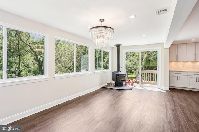 302 Fenwick Rd, Pilesgrove, NJ 08098 - unfurnished living room with baseboards, plenty of natural light, a wood stove, dark wood-style flooring, and recessed lighting