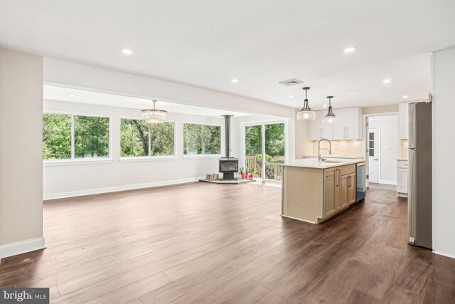 302 Fenwick Rd, Pilesgrove, NJ 08098 - kitchen with a sink, appliances with stainless steel finishes, a wood stove, light countertops, and open floor plan