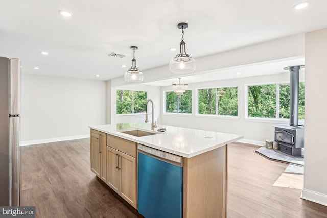 302 Fenwick Rd, Pilesgrove, NJ 08098 - kitchen featuring dishwashing machine, a sink, freestanding refrigerator, wood finished floors, and baseboards