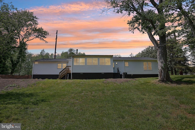 302 Fenwick Rd, Pilesgrove, NJ 08098 - back of house at dusk featuring entry steps, a lawn, crawl space, and a sunroom