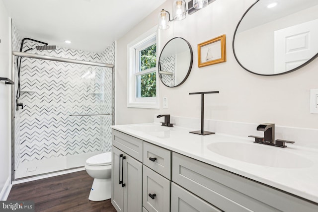 302 Fenwick Rd, Pilesgrove, NJ 08098 - full bathroom with a stall shower, double vanity, wood finished floors, toilet, and recessed lighting