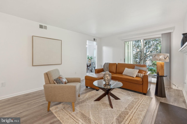 living room featuring light wood finished floors and baseboards
