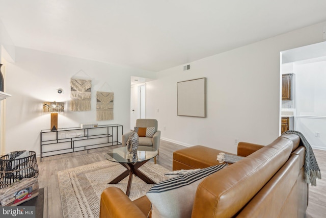 living room featuring wood finished floors and baseboards