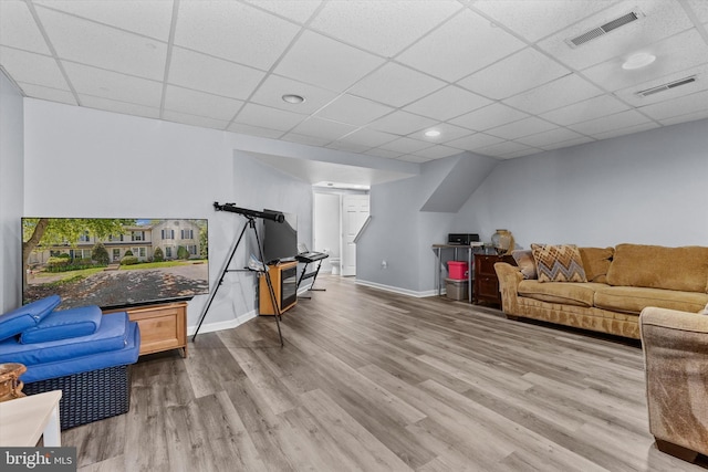 living area featuring wood finished floors, a paneled ceiling, and baseboards