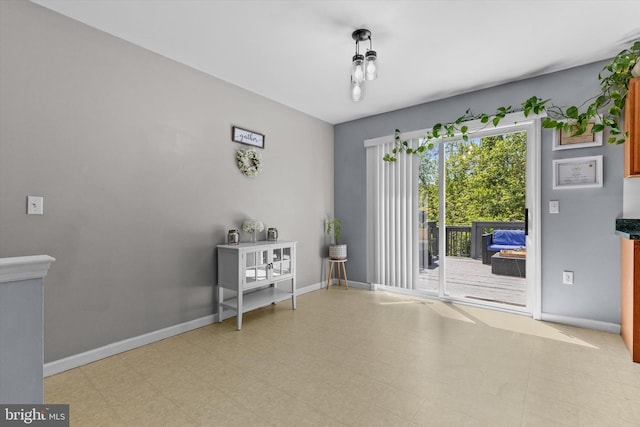 unfurnished room featuring baseboards and tile patterned floors
