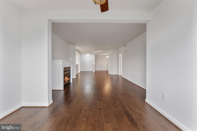 485 Harbor Side St Unit 405, Woodbridge, VA 22191 - unfurnished living room with dark wood-style floors, a glass covered fireplace, and baseboards