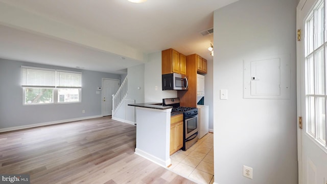 6940 Hawthorne St, Landover, MD 20785 - kitchen with appliances with stainless steel finishes, dark countertops, light wood finished floors, and baseboards