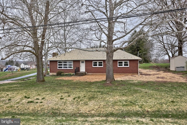 single story home featuring a front yard and brick siding