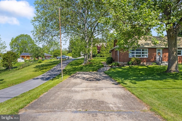 view of front of house with brick siding and a chimney