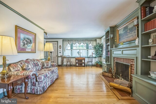 256 Crystal Ter, Haddonfield, NJ 08033 - living area with wood finished floors, crown molding, a brick fireplace, and built in features