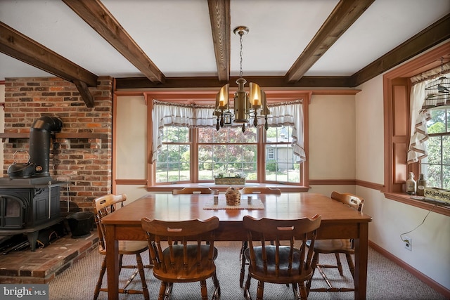 256 Crystal Ter, Haddonfield, NJ 08033 - dining room with a chandelier, a wood stove, beamed ceiling, baseboards, and carpet