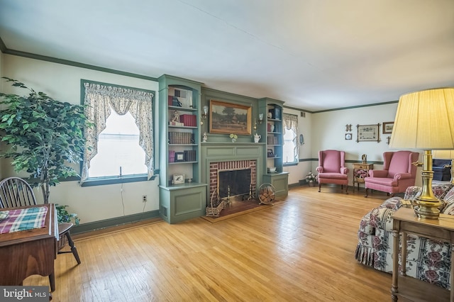 256 Crystal Ter, Haddonfield, NJ 08033 - living area with crown molding, a brick fireplace, light wood-style flooring, and baseboards