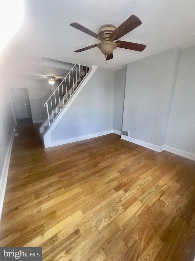 2136 E Tucker St, Philadelphia, PA 19125 - unfurnished living room with ceiling fan, stairway, wood finished floors, and baseboards