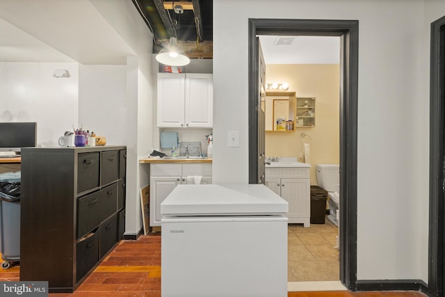 17 W Chase St, Baltimore, MD 21201 - washroom featuring a sink, a desk, and light tile patterned floors