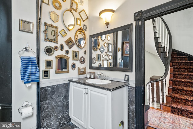 17 W Chase St, Baltimore, MD 21201 - bathroom featuring vanity, tile walls, and wainscoting