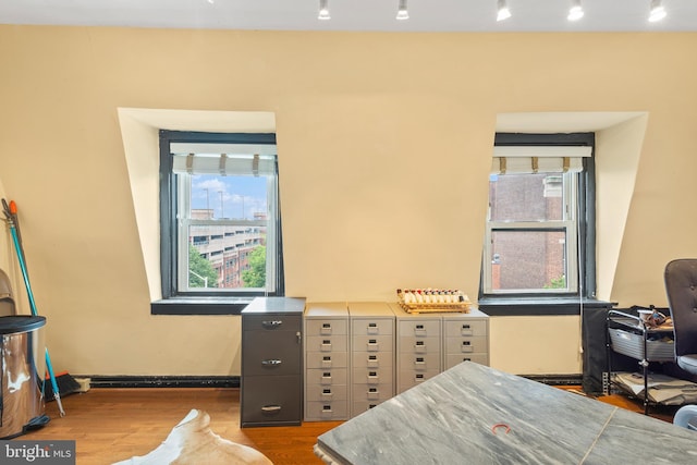 17 W Chase St, Baltimore, MD 21201 - bedroom featuring wood finished floors, track lighting, a desk, and baseboards