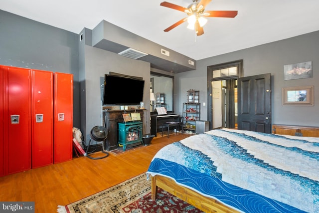 17 W Chase St, Baltimore, MD 21201 - bedroom featuring a wood stove and wood finished floors