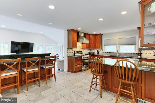 10621 Old Colchester Rd, Lorton, VA 22079 - kitchen featuring stainless steel appliances, wall chimney range hood, a sink, decorative backsplash, and dark countertops
