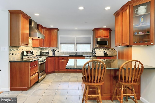 10621 Old Colchester Rd, Lorton, VA 22079 - kitchen with stainless steel appliances, wall chimney range hood, a sink, decorative backsplash, and recessed lighting