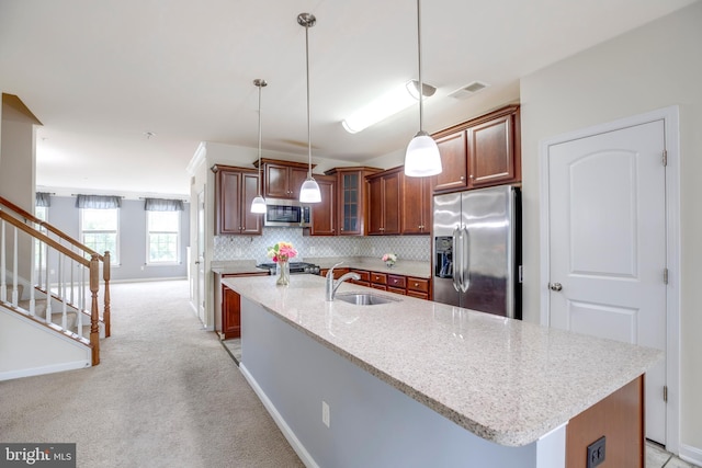 2527 Campus Way N Unit 69, Lanham, MD 20706 - kitchen featuring appliances with stainless steel finishes, a sink, pendant lighting, an island with sink, and light stone counters