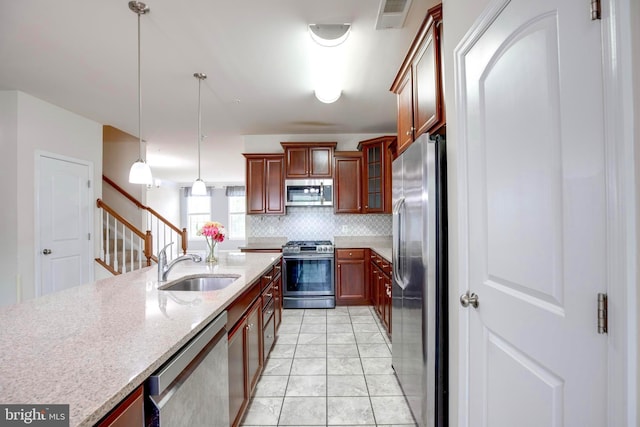 2527 Campus Way N Unit 69, Lanham, MD 20706 - kitchen with appliances with stainless steel finishes, a sink, decorative backsplash, hanging light fixtures, and light stone countertops