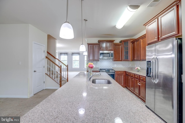 2527 Campus Way N Unit 69, Lanham, MD 20706 - kitchen featuring appliances with stainless steel finishes, light stone counters, decorative light fixtures, a sink, and glass insert cabinets