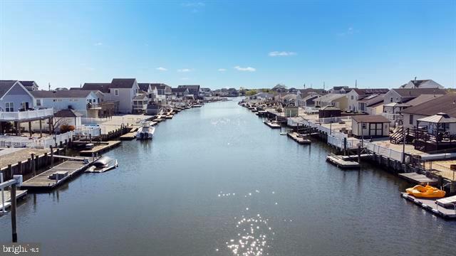 water view featuring a dock and nearby suburban area