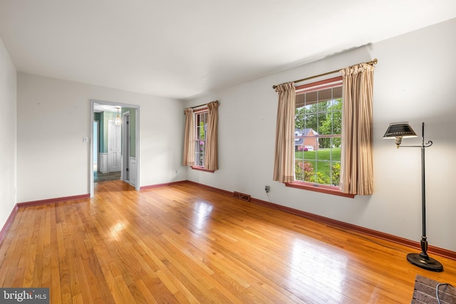empty room with light wood-type flooring and baseboards